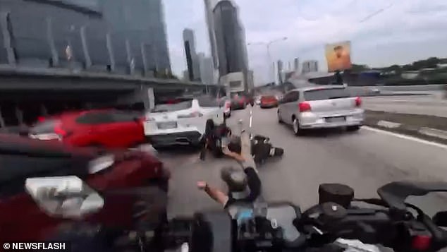 Chaos Erupts on Malaysian Motorway as Two-Year-Old Flings Car Door Open, Injuring Motorcyclist