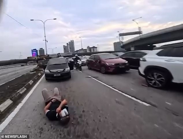Chaos Erupts on Malaysian Motorway as Two-Year-Old Flings Car Door Open, Injuring Motorcyclist